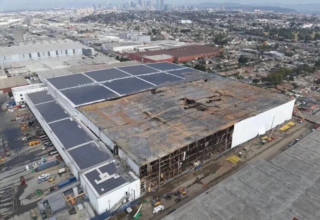 Lineage cold storage rooftop after 8-day solar fire, damaged PV array and burned warehouse roof