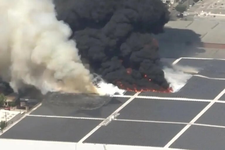 Closeup of rooftop solar panel array on fire, DC arc ignition at Lineage cold storage